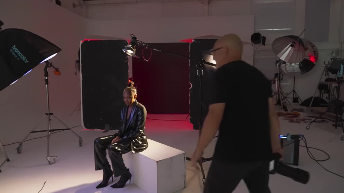 Taylor explaining gelled studio setup with red background and blue key light