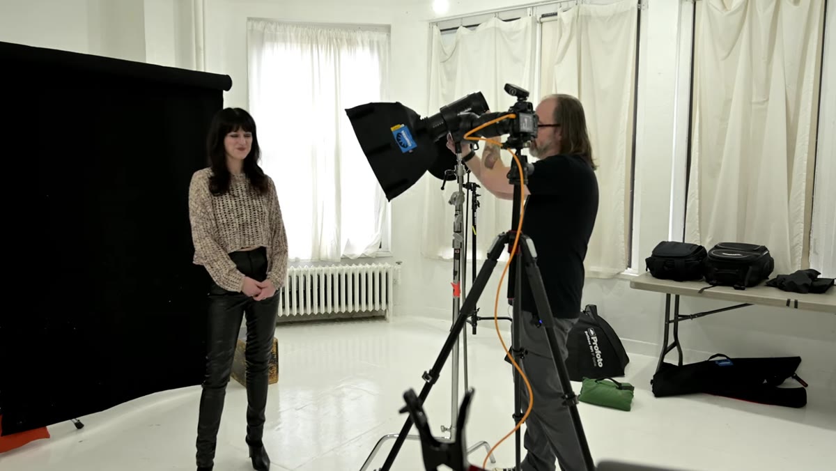 Softbox positioned above and to the side facing camera
