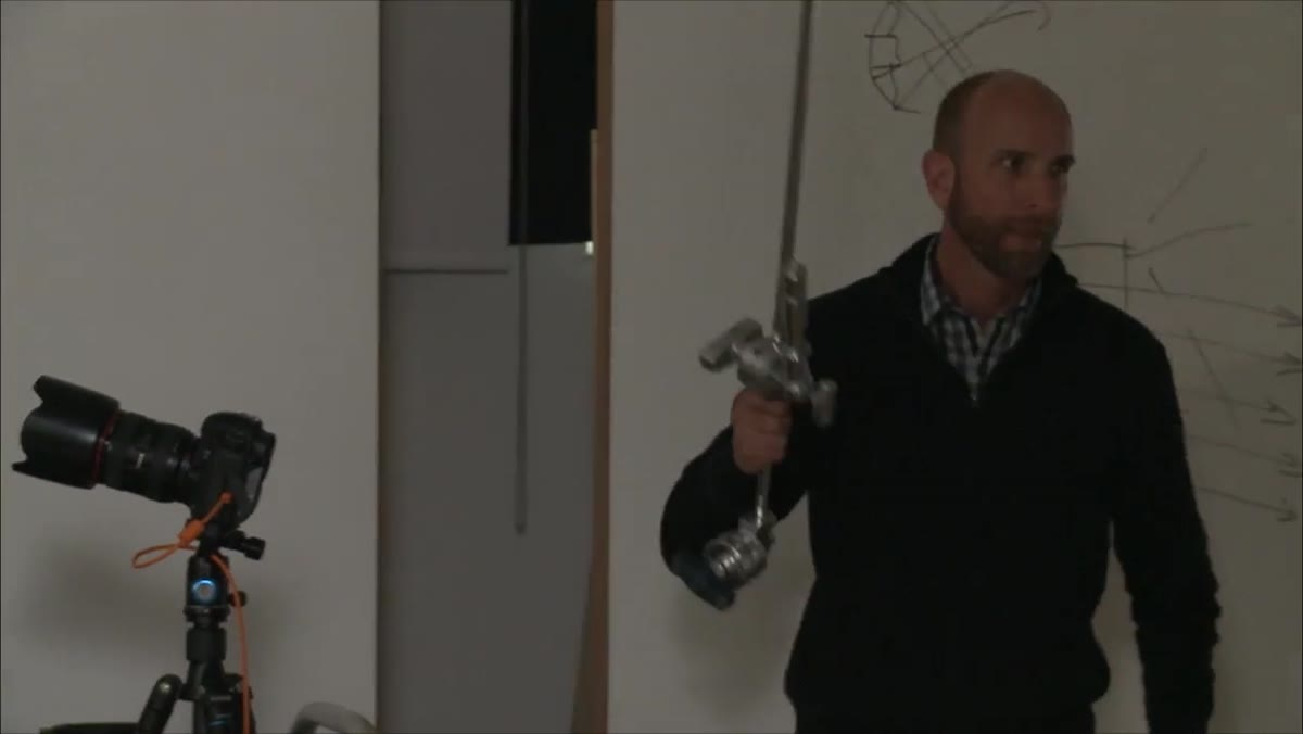Instructor attaching mini boom arm to light stand