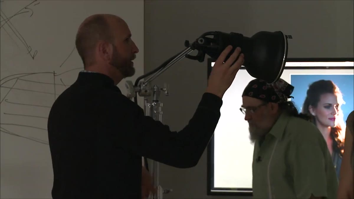 Beauty dish being attached to end of boom arm