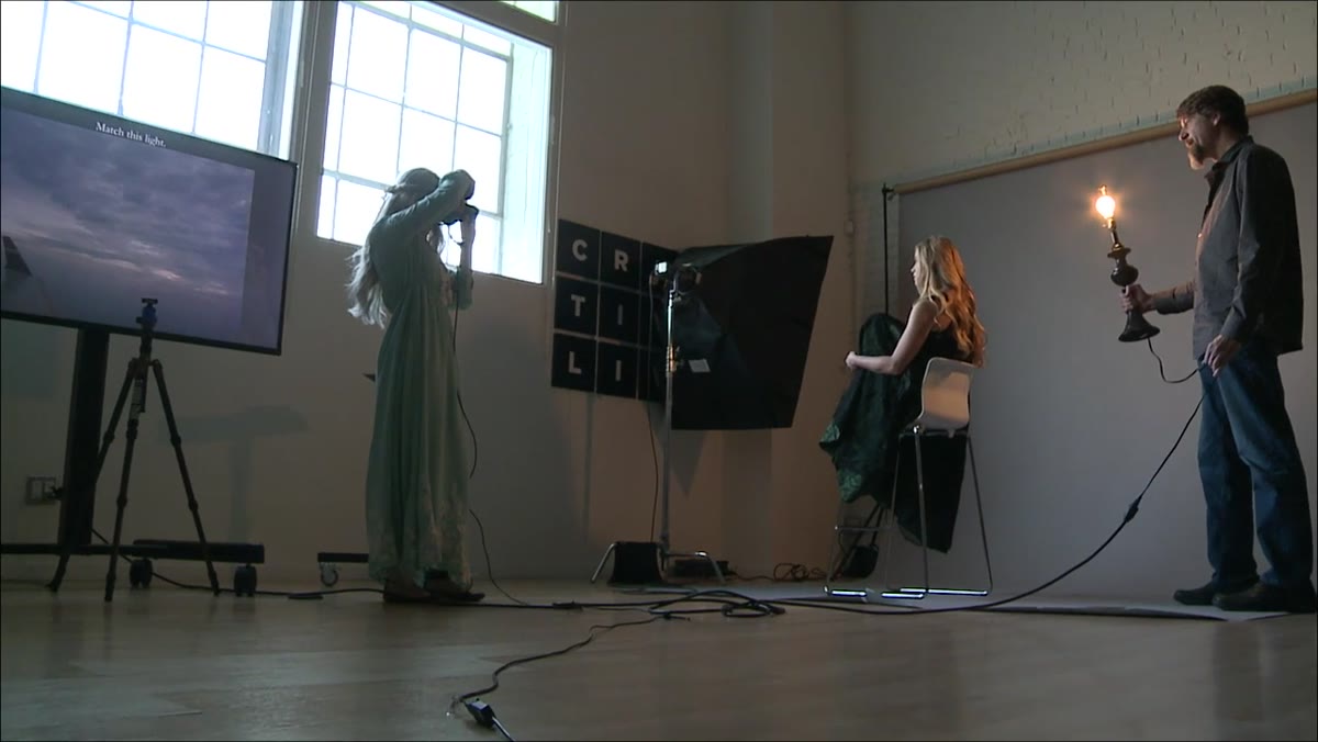 Photographer directing light position adjustments around subject