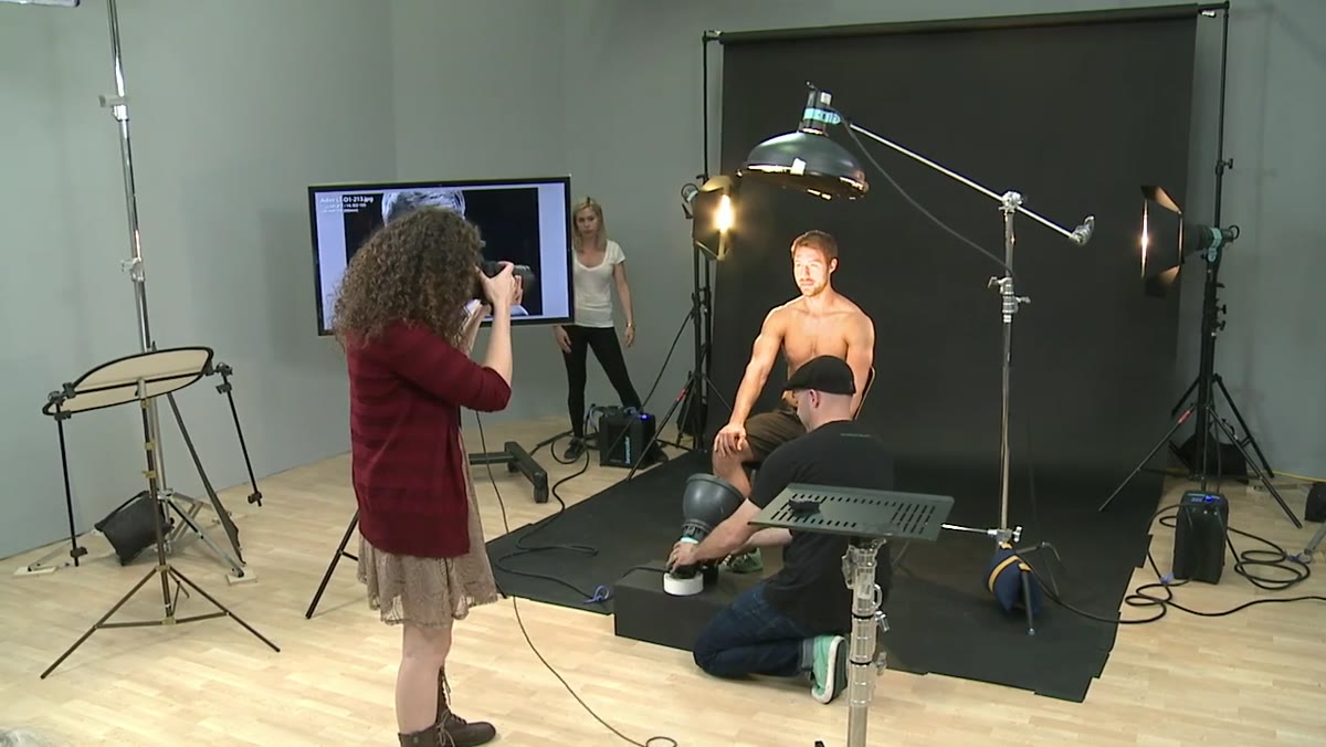 Test shot being reviewed, chin-down direction given to subject