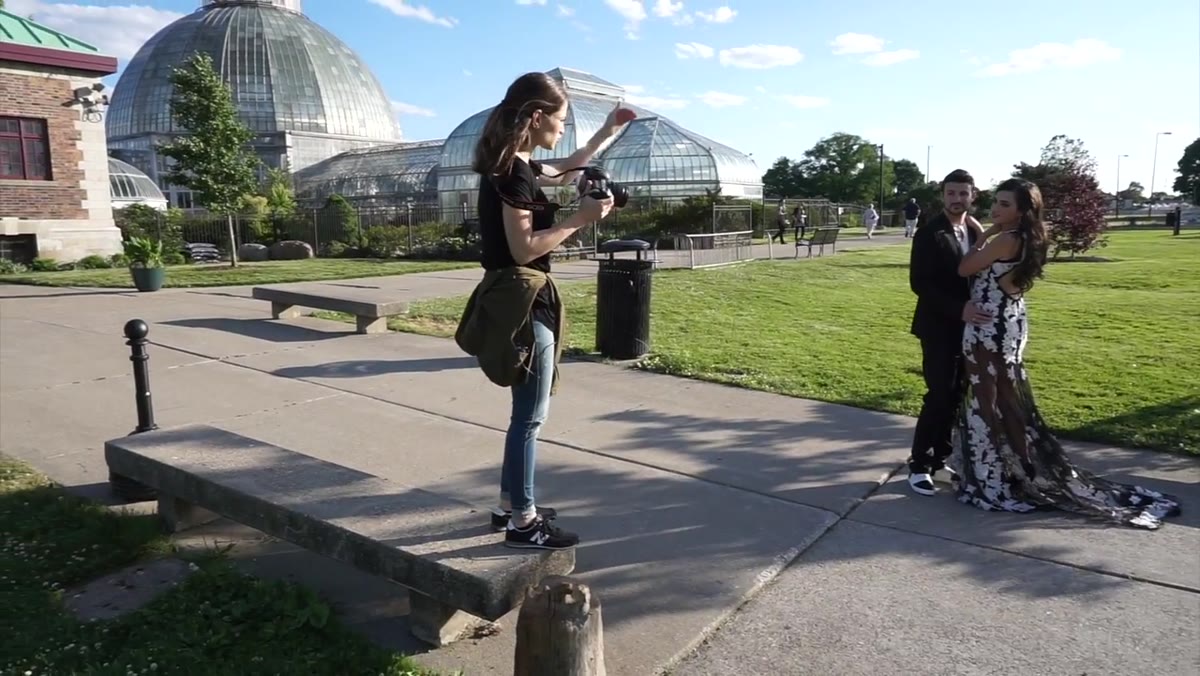 Photographer standing on an object to gain shooting height