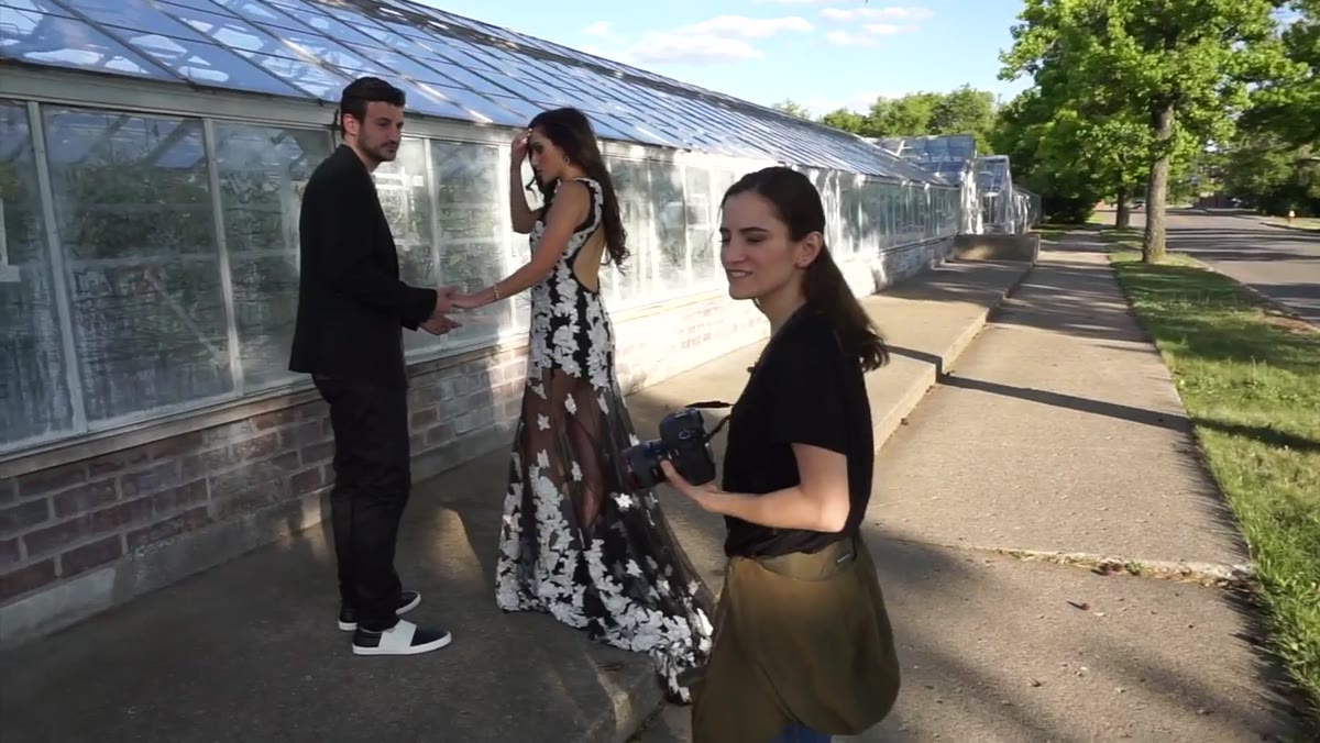 Photographer calling stop while couple is mid-movement on steps