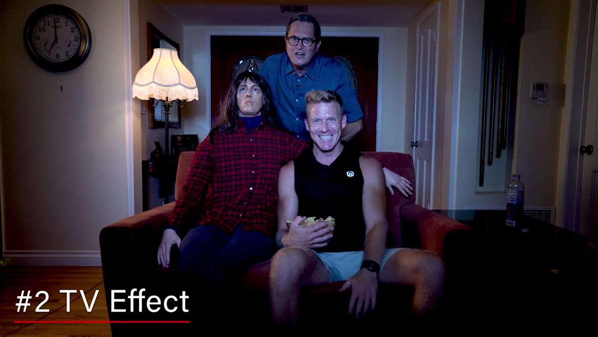 Subject lit by flickering cool-toned TV simulation light