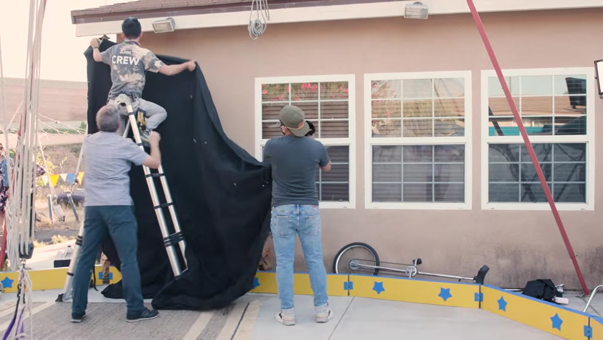 Black duvetyne fabric covering a house wall on camera left