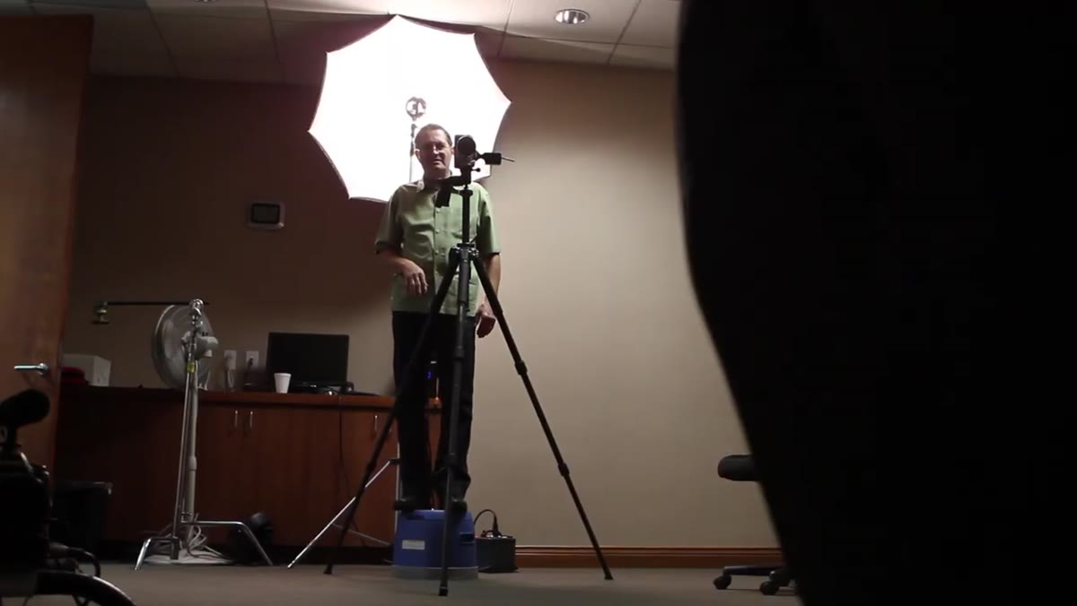 Umbrella fill light positioned behind camera