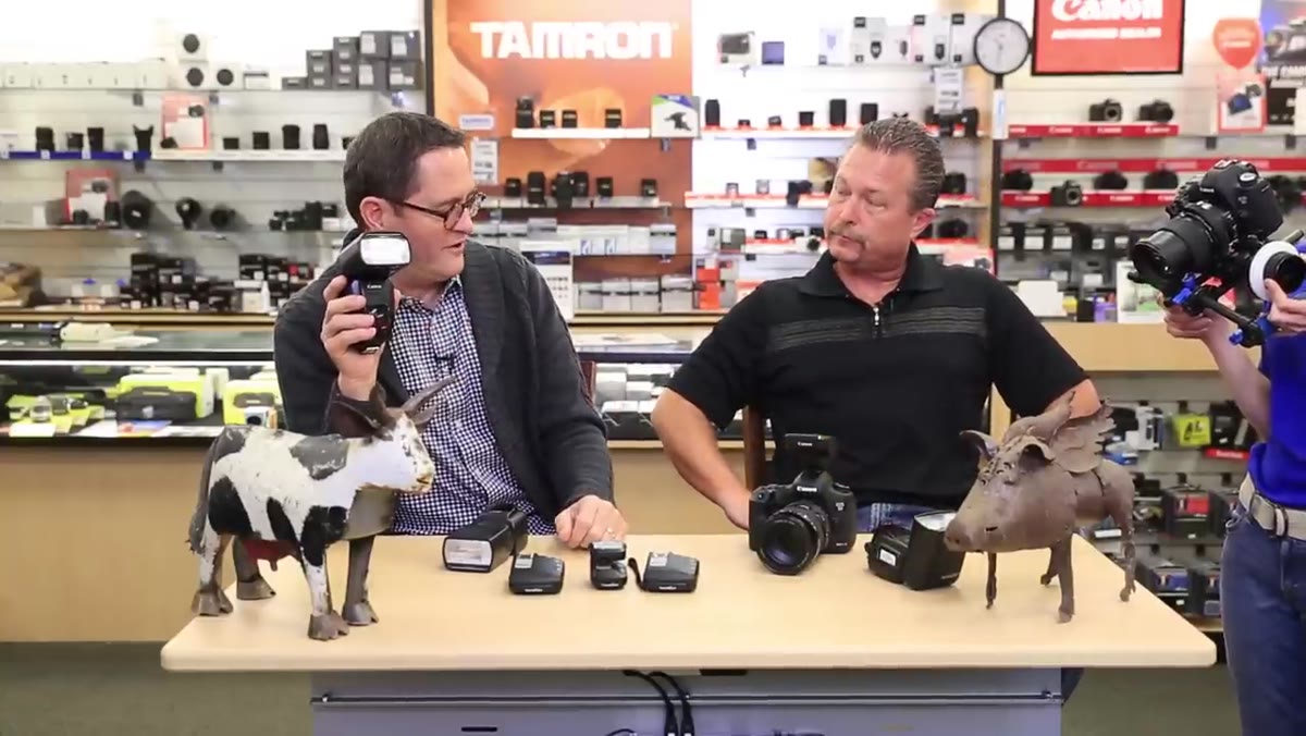 Photographer adjusting power compensation on individual speedlight