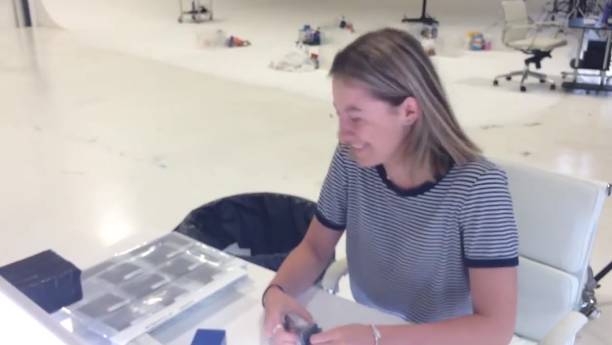 Clarice running a scalpel over old printed slides