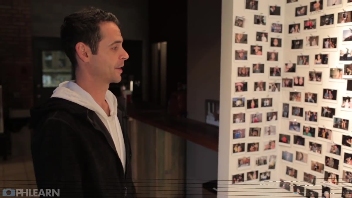 Logo wall covered in Polaroid photos of studio guests