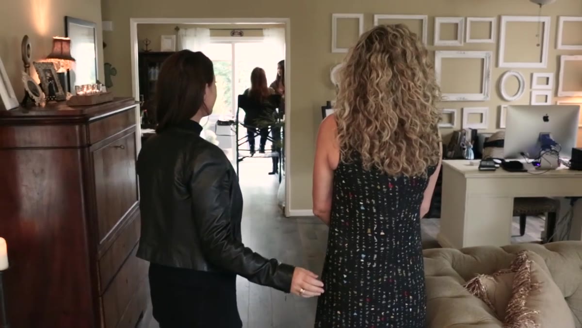 Ann and Sue standing in natural light living room