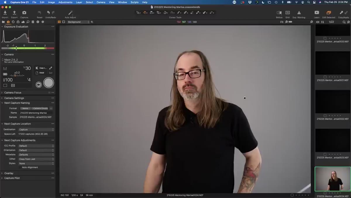 Studio with main light off, ambient light still visible on subject