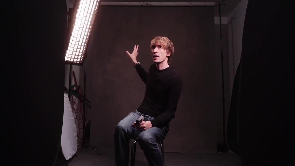 Tucker showing the Gravity hand-painted gray canvas backdrop