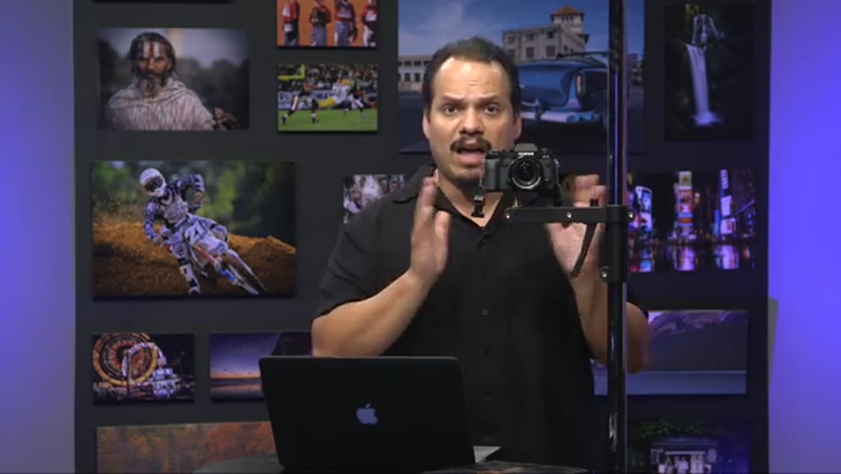 Photographer placing camera on stand with remote trigger attached