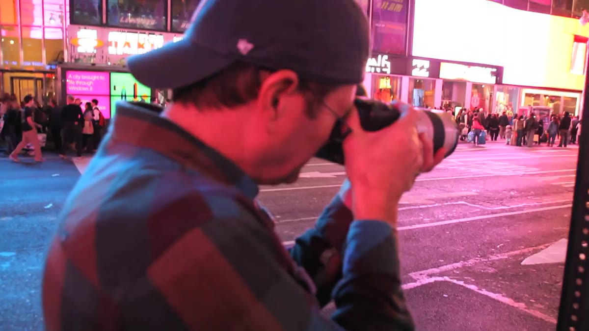 Times Square ambient light only, dark on subject&rsquo;s face