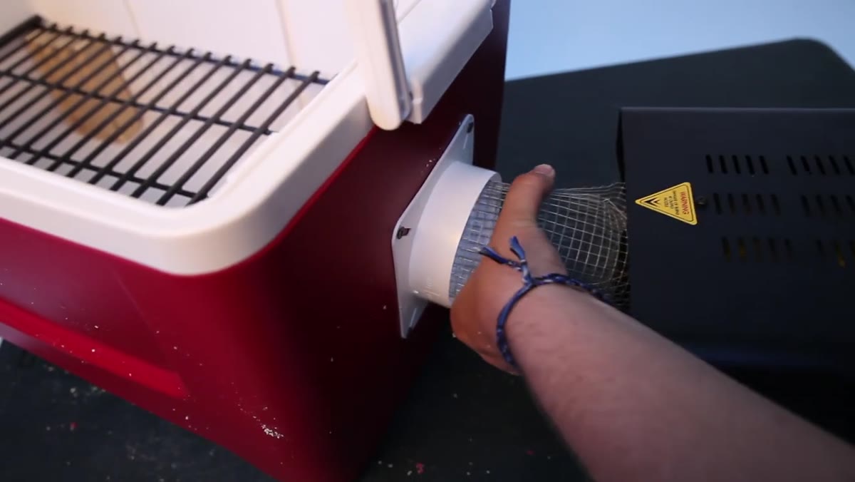Smoke being directed into the cooler intake through a screen tube