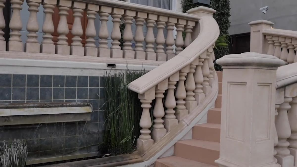 Both photographers moving to staircase with waterfall