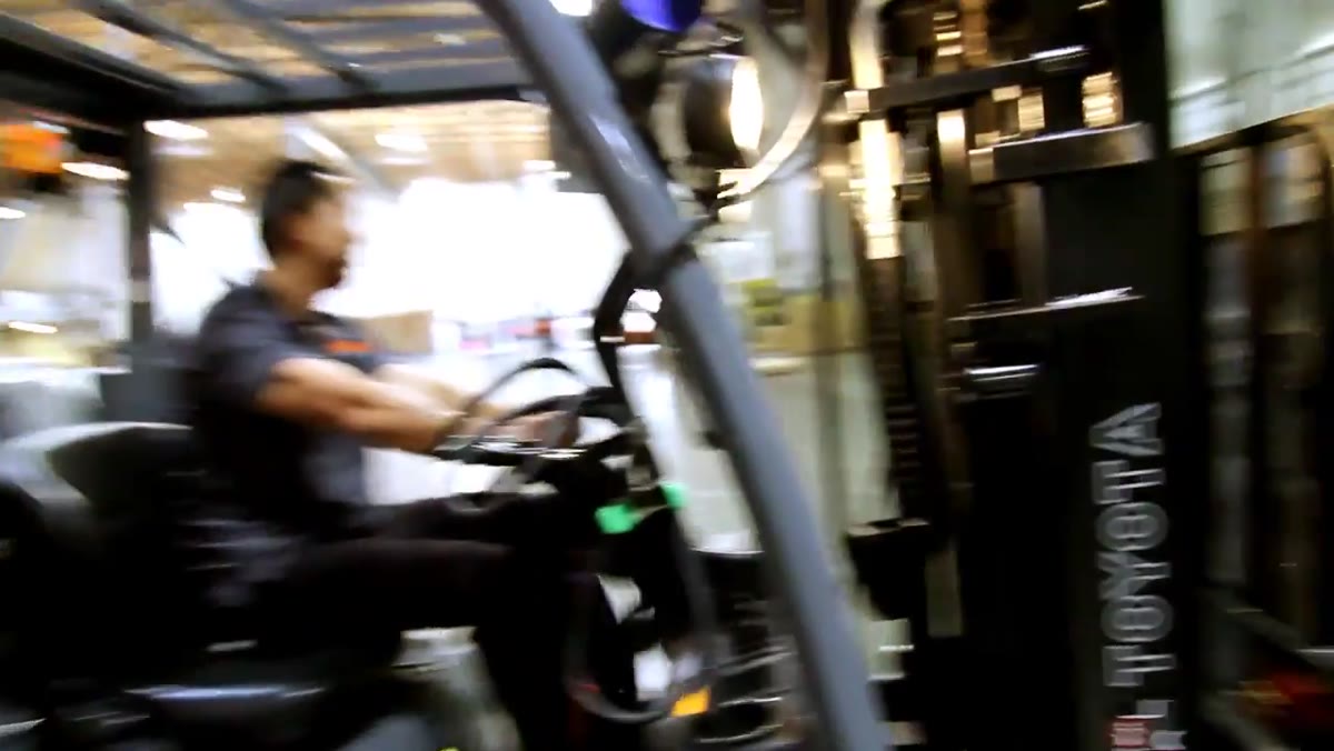 Second strobe being handheld alongside moving forklift