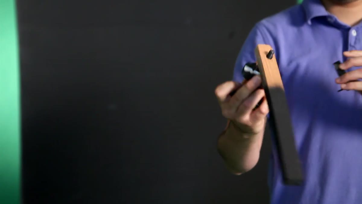 One-by-one wooden dowel suspended through C-stand with earthquake putty on top