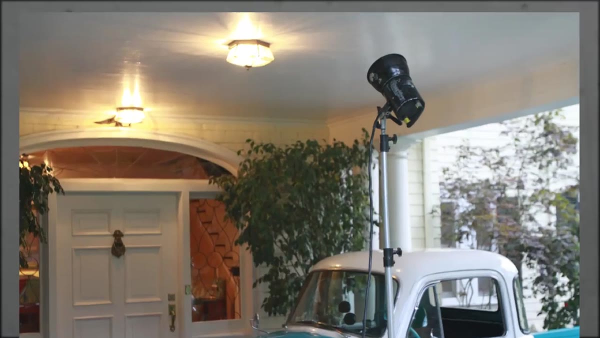 Background truck lit with overhead practical to simulate porch light