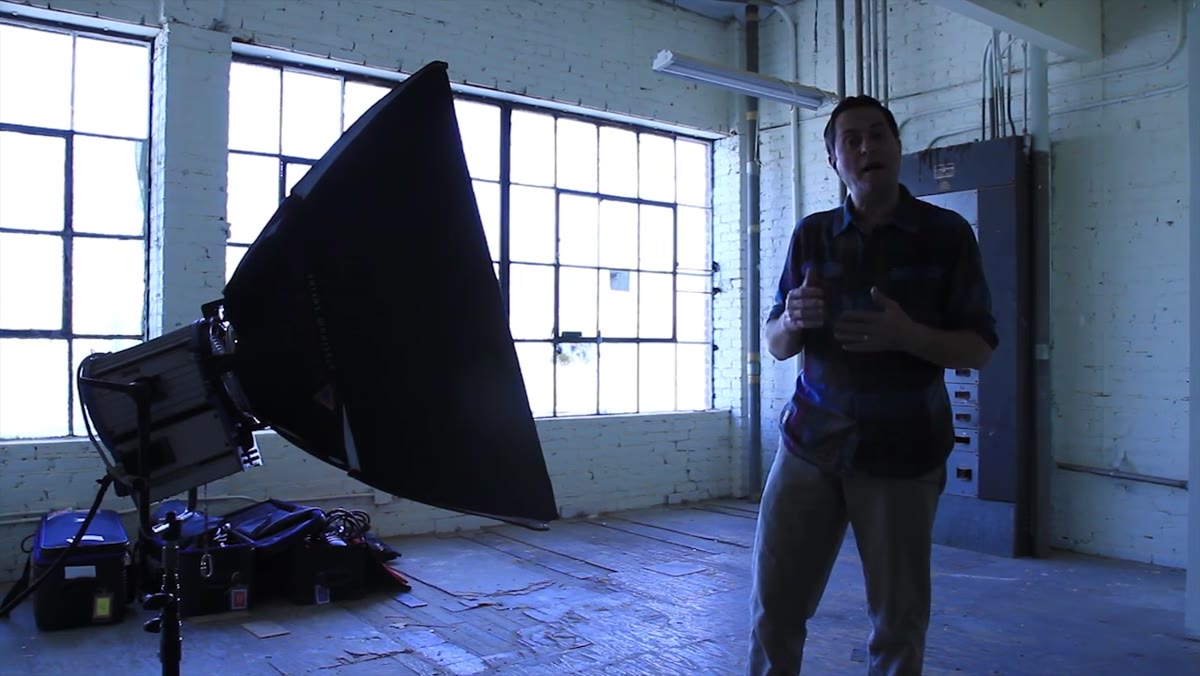 Tungsten video light on subject with blue window background visible