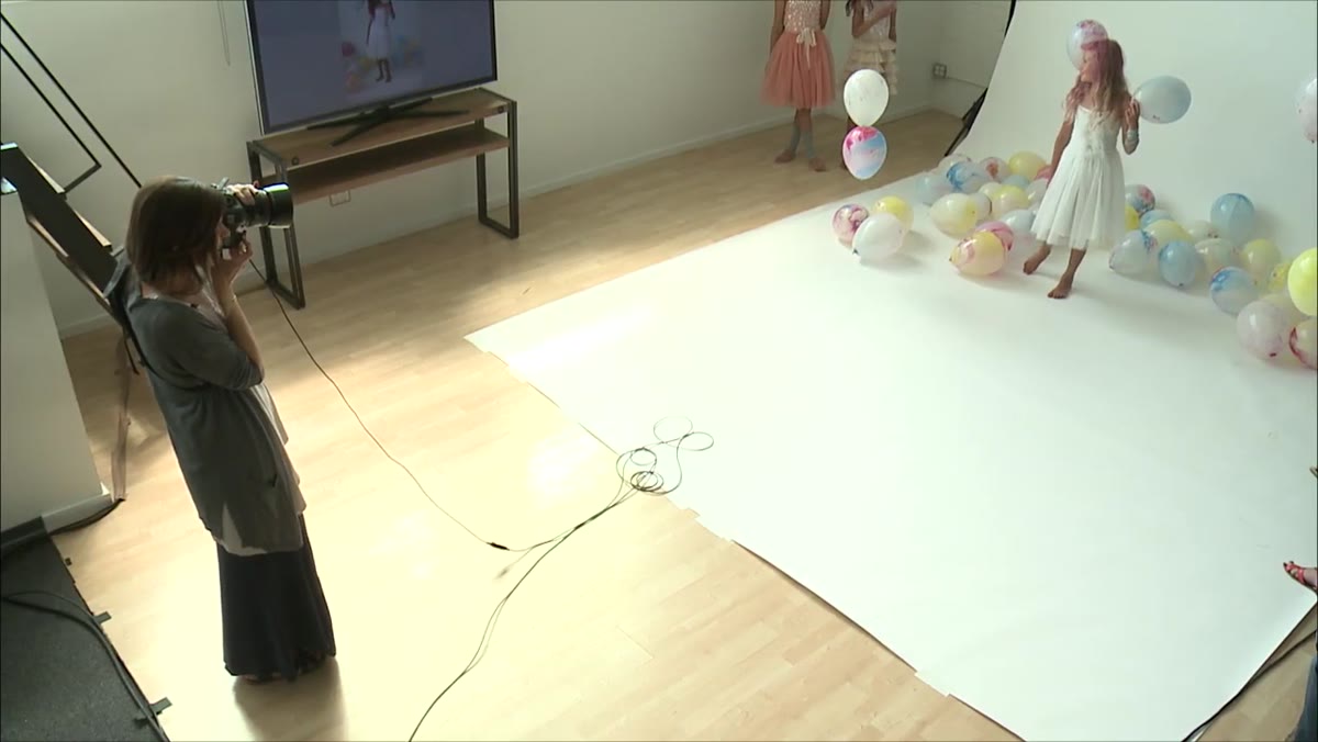 Child turning to laugh over her shoulder at another person off-frame
