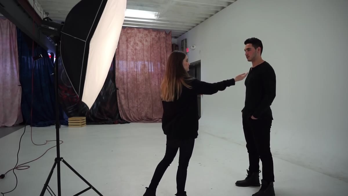 Photographer adjusting subject&rsquo;s shoulder position slightly
