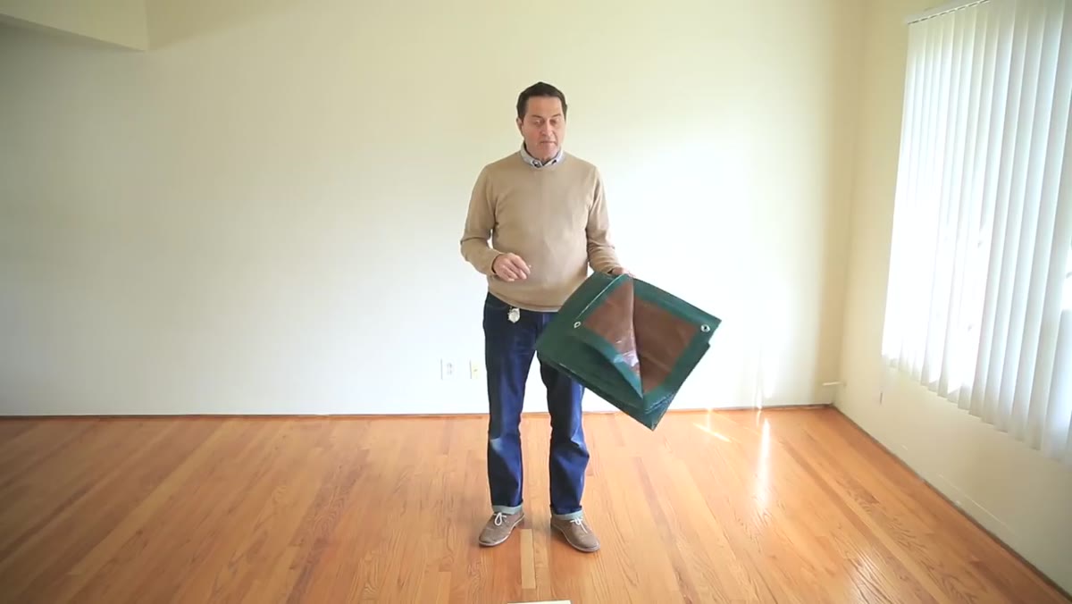 Tarp laid flat across hardwood bedroom floor