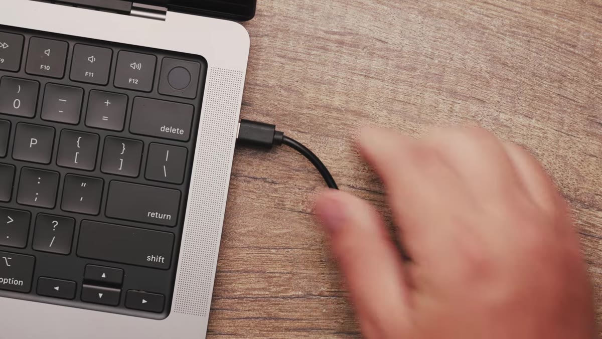 Hands connecting USB-C cable to computer and trigger