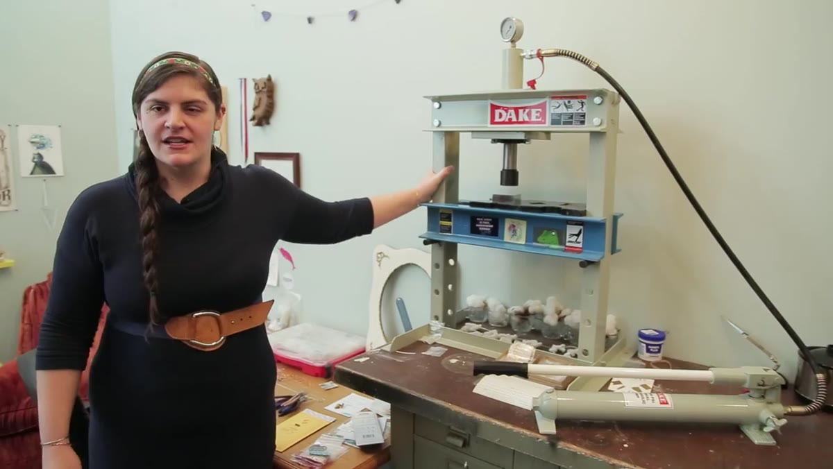 Alexa demonstrates the 10-ton hydraulic press with a steel stamp