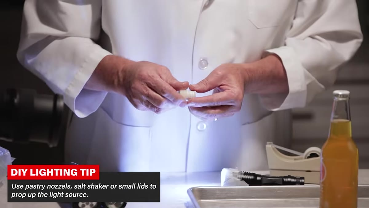 Flashlight resting on two pastry nozzles as a makeshift stand