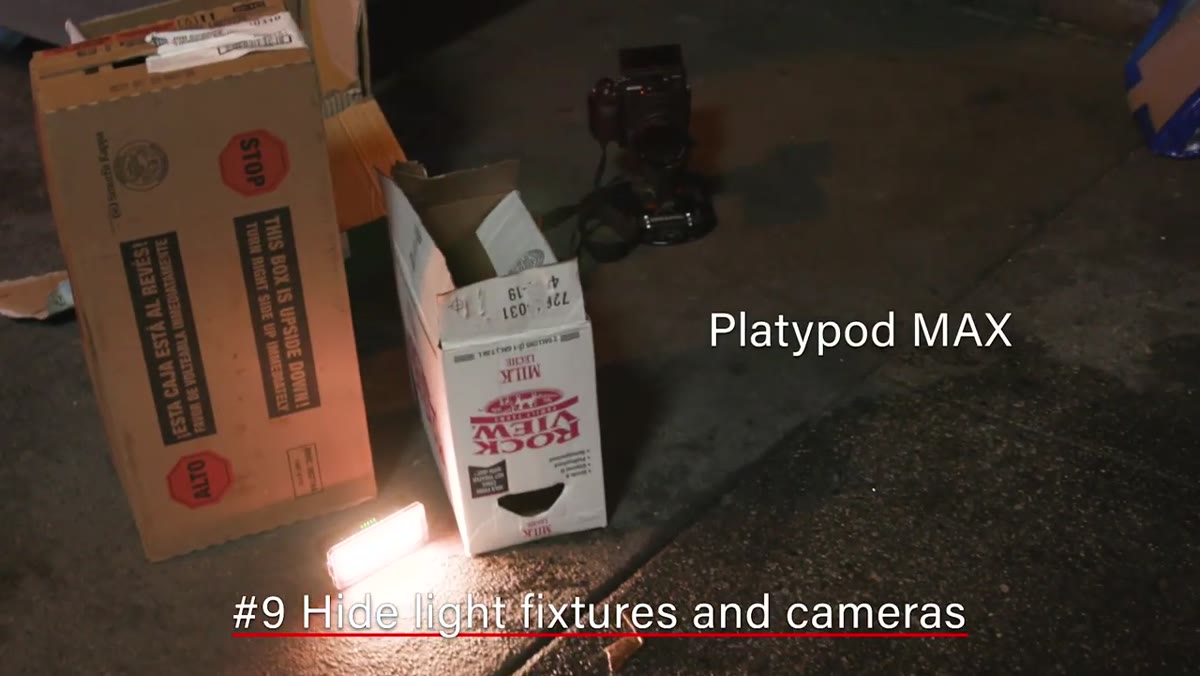 Cardboard boxes and alley debris used to conceal light fixtures