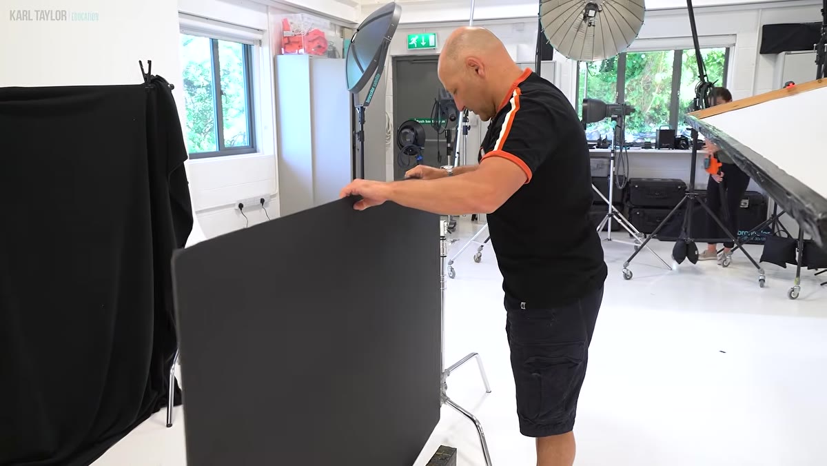 Three golf clubs arranged against dark foam board