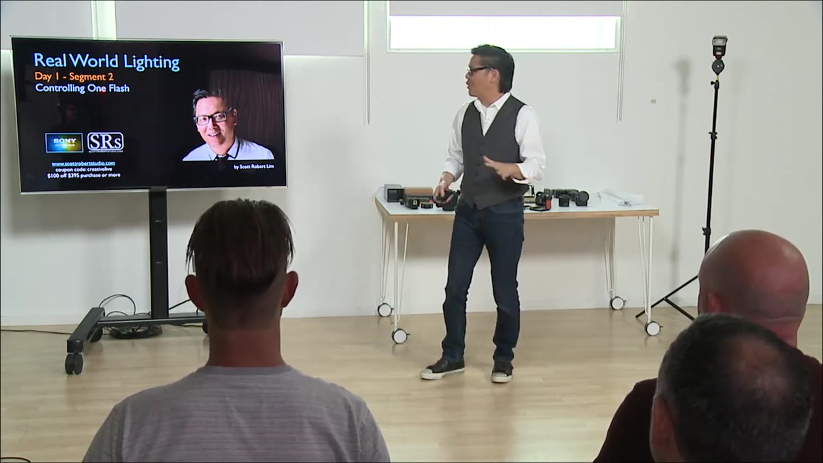 Instructor at shooting station explaining one-flash control