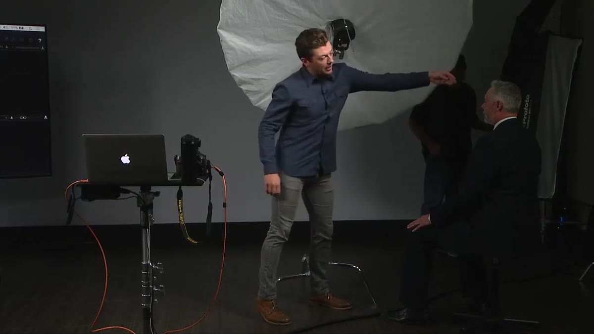 Back of umbrella aligned with subject&rsquo;s ear, light wrapping forward