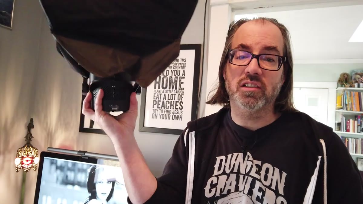 LED light with small softbox mounted on C-stand