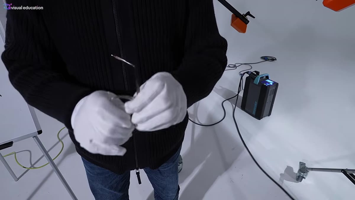 Karl demonstrating how to pop a lens out of an eyeglass frame by hand