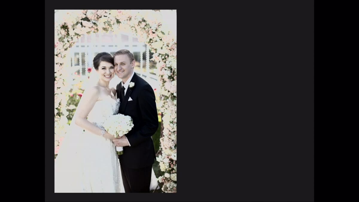 Couple in classic side-by-side wedding pose facing camera