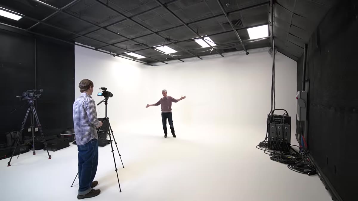 Tony standing inside a large white curved studio space