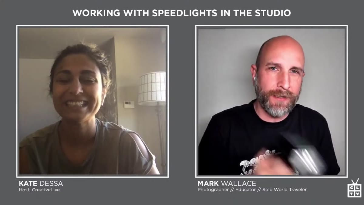Mark explaining the class focus to the camera, speedlights visible on table