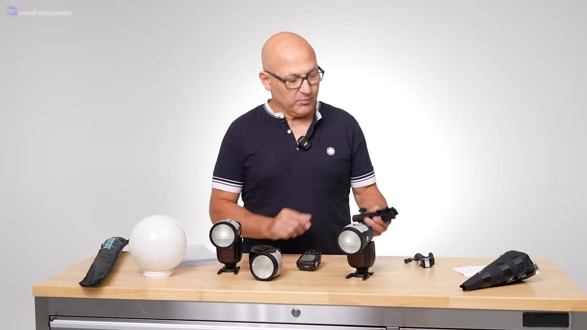Presenter attaching a DIY snoot and diffusion material to a speedlight