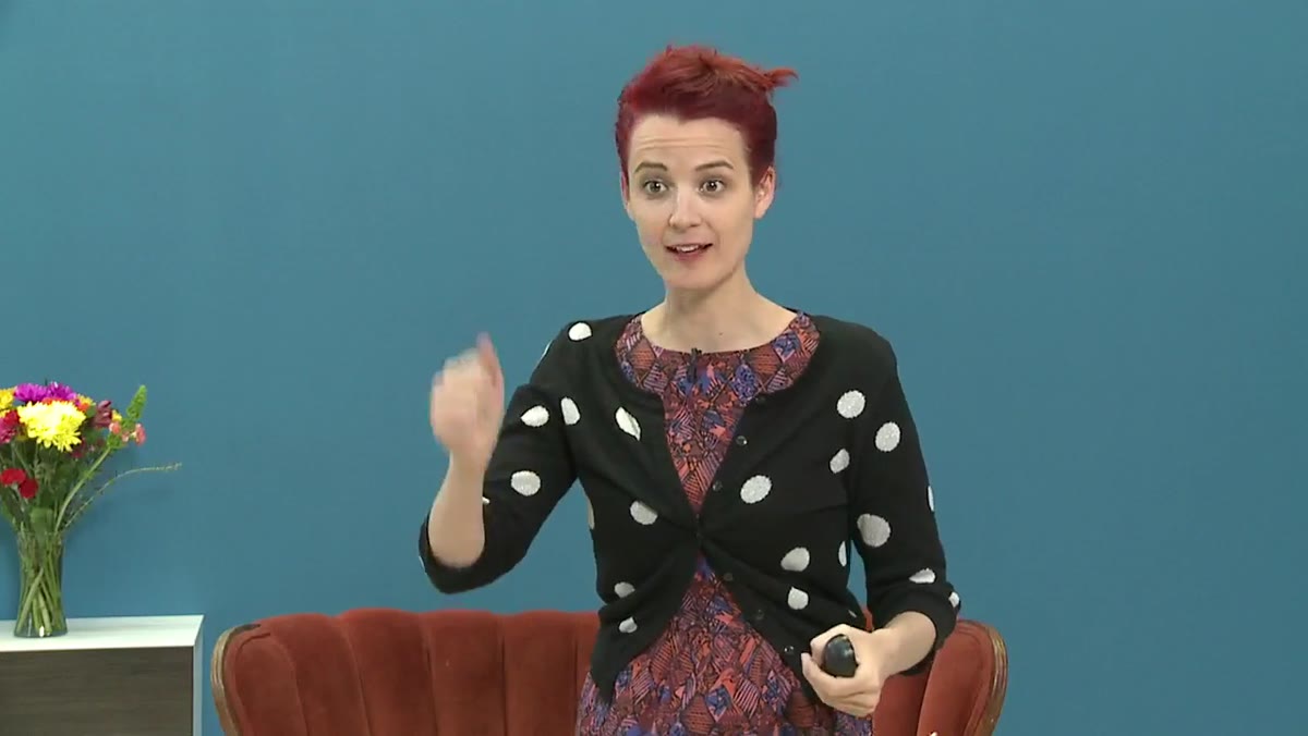 Presenter showing a vintage Polaroid Land Camera and film pack