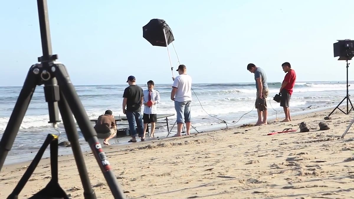 Ping pong table being positioned in shallow ocean water