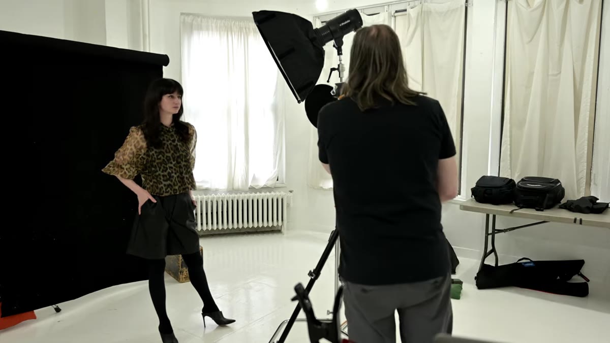 Photographer backs up and switches to longer focal length, then moves light closer