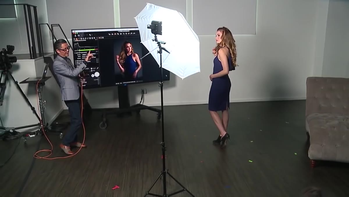 Instructor guiding the model&rsquo;s chin up to bring light into the eyes
