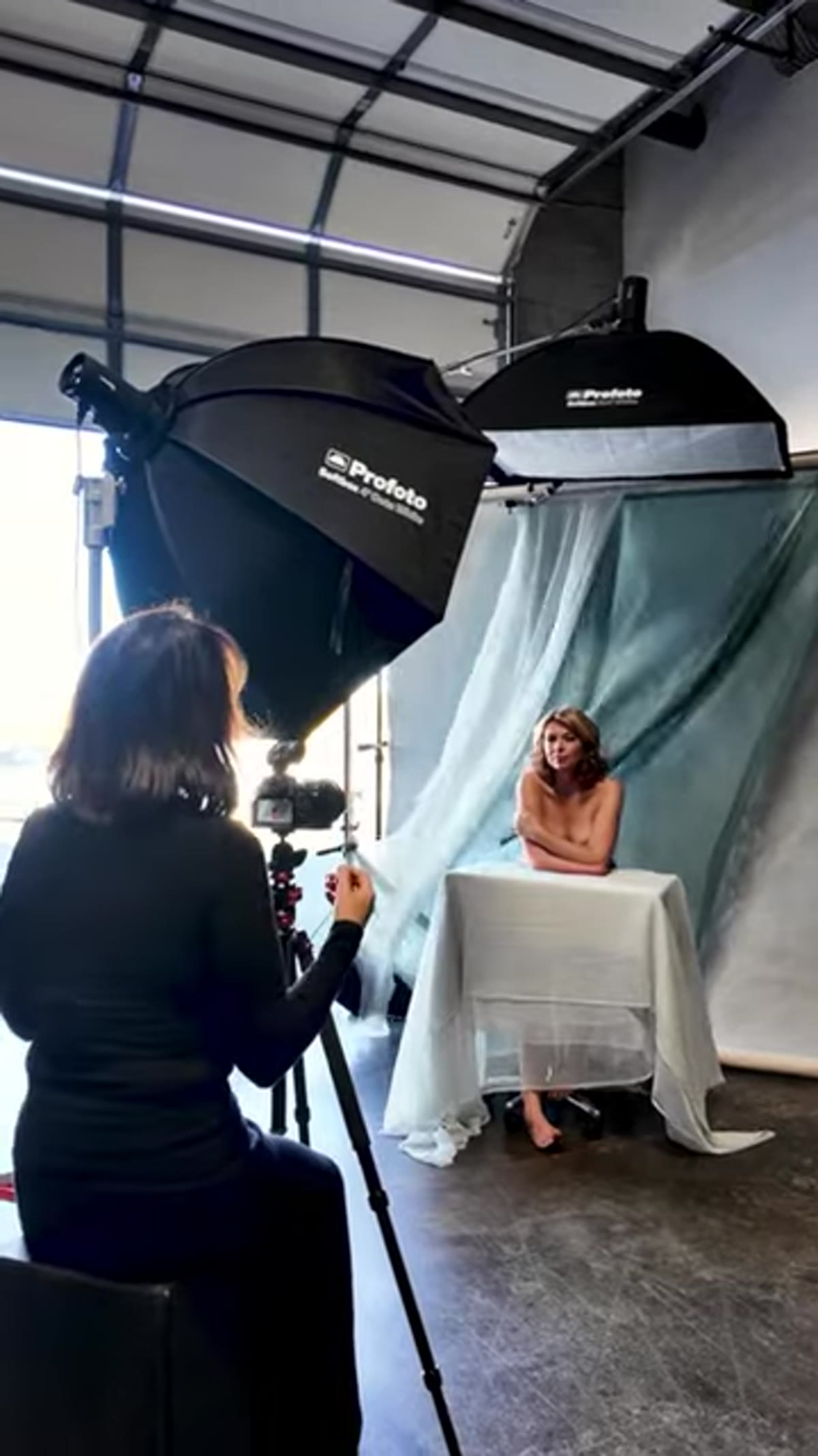 Rectangular softbox positioned high, angled downward toward subject