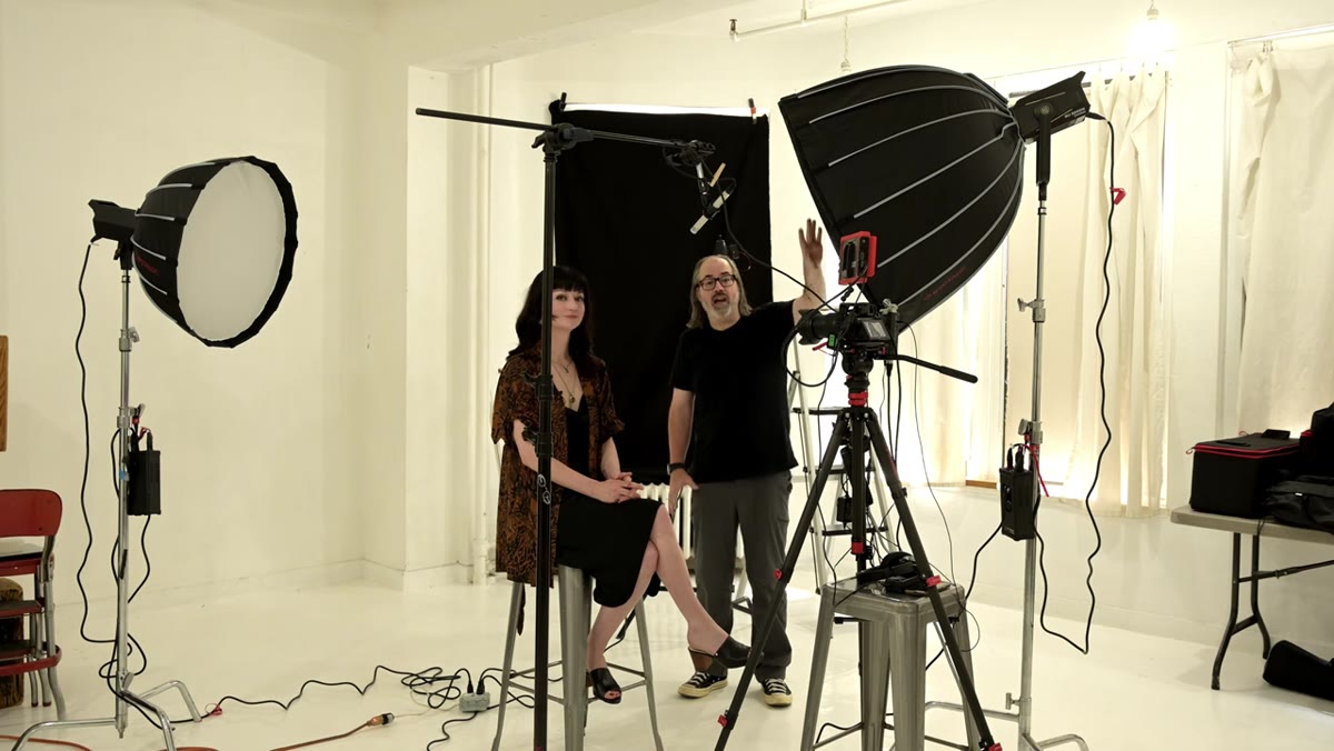 Three LED lights positioned around subject in studio