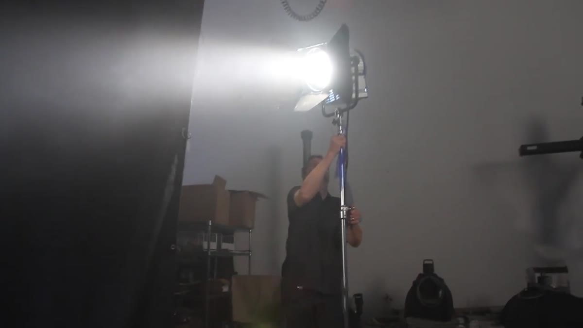 2K tungsten light placed far camera-right behind subject