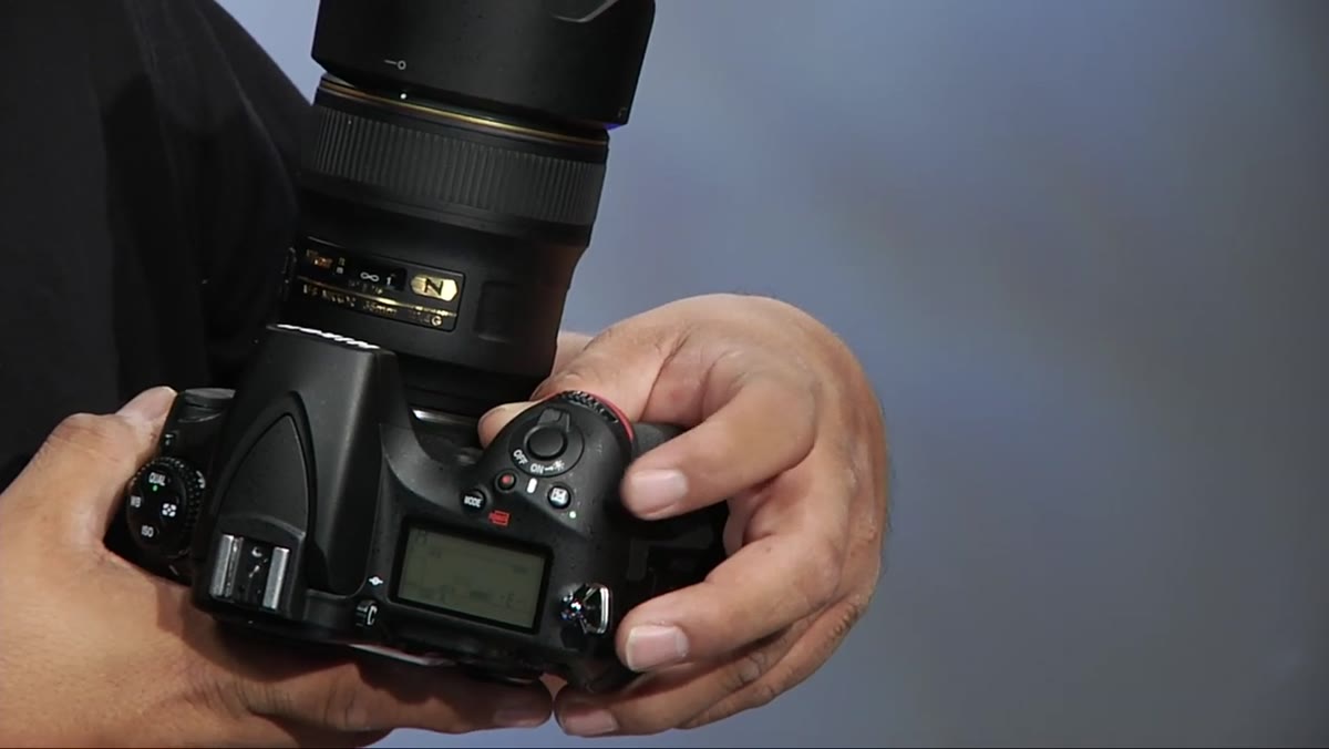 Exposure compensation button being used to underexpose the scene