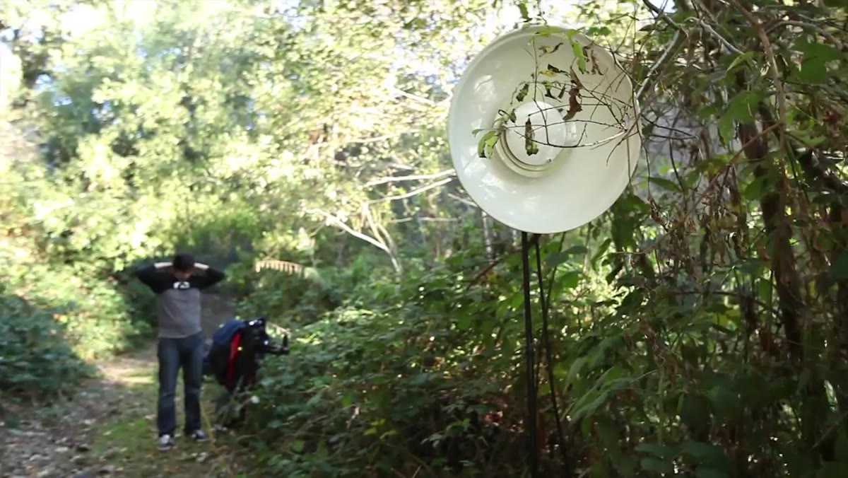 Assistant following rider with gridded beauty dish on face